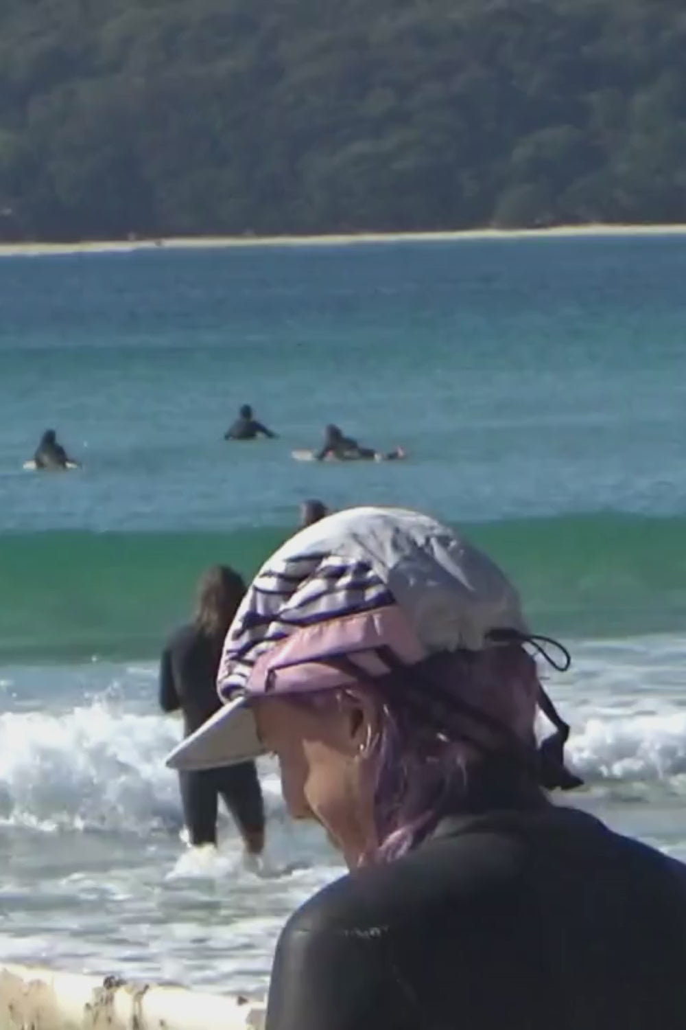 El Dingo surf cap with Sporty Zebra Pattern on surfer paddling out in Byron Bay